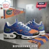 Florida Gators Nike Air Max running shoes in blue and orange with team logos, resting on a concrete surface.
