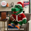 Florida Gators Santa Mascot Christmas Plush Toy wearing a red suit and holding a miniature brown football while seated.