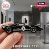 Ford GT40 Mk II Le Mans 60th Anniversary diecast car in black with number 2 livery held between fingers.