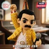 Freddie Mercury Crocheted Yarn Car Ornament wearing a yellow jacket and white trousers, holding a gray microphone.