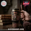 Ghost 20 Years Anniversary Stanley Tumbler Cup with black finish, skeleton artwork, and gold accents held in a hand.