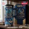 Gold Coast Titans 19th Anniversary Tie-Dye Handle Tumbler with blue patterned surface, team logo, and straw on a table.