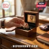 Gold Leo Zodiac Signet Ring with a lion head emblem inside a dark wooden box on a desk.