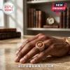 Gold Leo Zodiac Signet Ring featuring a red enamel inlay with a lion relief, set on a person's hand in a library setting.