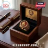 Gold Leo Zodiac Signet Ring with a red center stone and lion emblem, displayed in a wooden gift box on a desk.