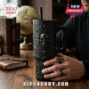 Gothic Skull Snake Black Stanley Tumbler 40oz with embossed relief patterns on a desk with a hand holding the handle.