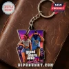 Grand Theft Auto VI Vice City keychain featuring a Roman numeral VI logo with two game characters on a brown leather surface.