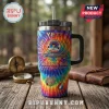 Grateful Dead 1965-2026 Anniversary YETI Tumbler Cup featuring psychedelic tie-dye art and guitar graphic on wood table.