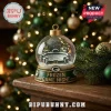 Green Bay Packers 24-Day Christmas Advent Calendar snow globe featuring Lambeau Field on a wooden table.