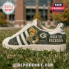 Green Bay Packers Heritage Mascot Casual Shoes featuring a cheesehead mascot, team logo, and grass field background.
