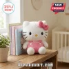 Hello Kitty Soft Plush Doll featuring white fur, pink overalls, and a matching pink bow sitting on a wooden shelf.