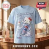 Hello Kitty x Pepsi Cream Soda 2026 T-Shirt in light blue featuring a graphic of Hello Kitty holding a Pepsi soda can.