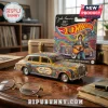 Hot Wheels John Lennon 85th Anniversary Rolls-Royce car with colorful psychedelic floral paint on a wooden desk.