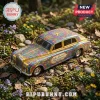 Hot Wheels John Lennon 85th Anniversary Rolls-Royce car featuring vibrant yellow psychedelic floral patterns on grass.