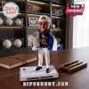 Houston Astros Yordan Alvarez resin bobblehead figure wearing a white cap and holding a silver trophy on a desk.