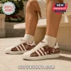 Indiana Hoosiers NCAA Mascot Casual Shoes in white with maroon stripes, mascot graphic, and campus imagery on side panels.