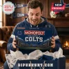 Indianapolis Colts Monopoly Collector Edition board game box held by a man wearing a blue team hoodie in a living room.