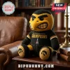 Iowa Hawkeyes Heroes Game Champions plush toy in black and yellow, featuring team logo on feet and trophy graphic on chest.