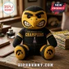 Iowa Hawkeyes Heroes Game Champions plush toy in black and gold yarn, featuring a mascot head and trophy embroidery.