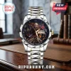 Iron Maiden Eddie Premium Quartz Watch featuring a metal band, skeleton dial, and British flag graphic on a wooden desk.