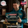 Jacksonville Jaguars Monopoly Collector Edition Board Game held by a man wearing a teal and black team hoodie.