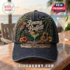 Jimmy Buffett Premium Charcoal Baseball Cap with a colorful tropical parrot, guitar, and sunset embroidered graphic.