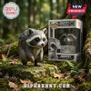 Jimothy The Raccoon Seattle Vinyl Figure standing on a mossy rock in a forest next to its illustrated display box.