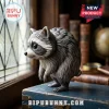 Jimothy The Raccoon Seattle Vinyl Figure standing on a blue wooden box with a blurred library bookshelf background.