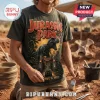 Jurassic Park Life Finds A Way Black Shirt featuring a T-Rex, jungle foliage, and park gates on a distressed fabric base.