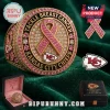 Kansas City Chiefs Breast Cancer Awareness ring with pink ribbon motif, gold plating, and pavé crystals on green velvet.