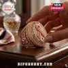 Kansas City Chiefs Breast Cancer Awareness ring with gold finish, pink ribbon accents, and team logos on a wooden surface.