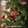 Kansas City Chiefs Christmas Advent Calendar 2026 ornament featuring a red team helmet hanging on a lit pine tree.