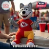 Kansas City Chiefs Wolf Mascot Plush Toy wearing a red team shirt and split red and gold pants sitting on a cooler.
