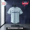 Karol G Album Signature Light Blue Baseball Jersey with dark navy text and matching trim on a display stand.