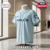 Karol G Album Signature Light Blue Baseball Jersey with dark blue text and barbed wire sleeve detailing on a mannequin.