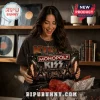 KISS Rock Band Collector Edition Monopoly Board Game box held by a woman in a black shirt in a room with music decor.