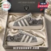 Las Vegas Raiders Denim Canvas Casual Shoes featuring team logos, grey fabric texture, and white stripes in a display box.