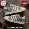 Las Vegas Raiders Denim Canvas Casual Shoes featuring grey fabric, white stripes, team logo, and city skyline graphics.