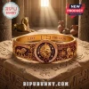 Lion Strength Horoscope Engraved Bracelet in gold featuring Leo zodiac symbols and a central lion head on stone pedestal.