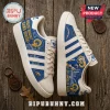 Los Angeles Rams Adidas Campus Casual Shoes in blue and white with team mascot, logo, and text on a rustic wooden table.