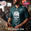 Luke Combs Philadelphia Eagles 2027 Tour football jersey in midnight green with a skull graphic wearing a baseball cap.