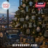 Manchester City Blue Moon 24-Day Christmas Ornament Advent Calendar box next to a decorated tree with team-themed ornaments.