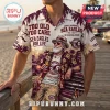 Manly-Warringah Sea Eagles Maroon Hawaiian shirt with tropical palm patterns, vintage beer graphics, and text on a beach.