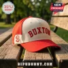 Minnesota Twins Byron Buxton embroidered hat featuring red panels, a cream front, and red lettering on a wooden bench.