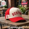 Minnesota Twins Byron Buxton embroidered hat featuring a cream front panel, red brim, and red text on a wooden table.