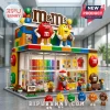 M&M's Candy Store Building Block Set featuring red and yellow M&M figures on a multicolored brick storefront structure.