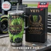 Monster Energy 24th Anniversary Edition Yeti Tumbler Cup with green tie-dye print and black handle on metal surface.