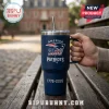New England Patriots 1776-2026 America 250 Stanley Tumbler in navy blue with a straw, held by a hand on a wooden bench.