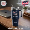 New England Patriots 1776-2026 America 250 Stanley Tumbler in navy blue with a metal straw on a wooden desk.