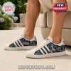 New England Patriots Adidas Casual Sneakers featuring blue team graphics, white suede overlays, and classic stripe detailing.
